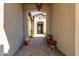 Inviting entryway with arched opening and decorative wrought iron door at 31023 N 117Th Dr, Peoria, AZ 85383