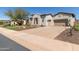 Beautiful home exterior with a large driveway and desert landscaping at 31023 N 117Th Dr, Peoria, AZ 85383