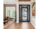 Elegant foyer with wrought iron door, wood floors, and modern accents at 31023 N 117Th Dr, Peoria, AZ 85383