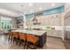 Spacious kitchen featuring a large island with seating and open layout dining and living areas at 31023 N 117Th Dr, Peoria, AZ 85383