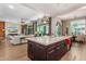 Modern kitchen island in an open layout, with a view of the backyard and adjoining living area at 31023 N 117Th Dr, Peoria, AZ 85383