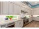 Stylish kitchen with stainless steel appliances, light countertops, and hardwood flooring at 31023 N 117Th Dr, Peoria, AZ 85383