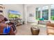 Bright living room with a media console, stylish seating, and views to the outdoors at 31023 N 117Th Dr, Peoria, AZ 85383