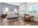 Bright primary bedroom featuring hardwood floors, neutral tones, and multiple windows at 31023 N 117Th Dr, Peoria, AZ 85383