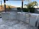 Modern outdoor kitchen with stainless steel appliances and granite countertops at 31023 N 117Th Dr, Peoria, AZ 85383