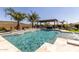 Luxury pool area with a built-in grill and stunning desert views at 31023 N 117Th Dr, Peoria, AZ 85383