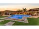 Inviting backyard pool with lush landscaping and outdoor kitchen at 31023 N 117Th Dr, Peoria, AZ 85383