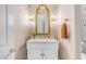 Elegant powder room boasting designer wallpaper, marble countertop, and gold-toned fixtures at 31023 N 117Th Dr, Peoria, AZ 85383
