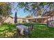 Spacious backyard with lawn, patio table, and trees at 3601 W Solano Dr, Phoenix, AZ 85019