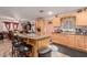 Kitchen with light wood cabinets and an island at 3601 W Solano Dr, Phoenix, AZ 85019