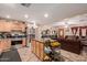 Kitchen with light wood cabinets, granite island, and view to living room at 3601 W Solano Dr, Phoenix, AZ 85019