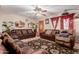 Living room with brown leather sofas and a patterned rug at 3601 W Solano Dr, Phoenix, AZ 85019