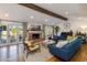 Cozy living room featuring a brick fireplace and hardwood floors at 3734 E Pierson St, Phoenix, AZ 85018