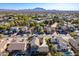 Aerial view of a two-story house with a landscaped yard and a neighborhood in the background at 3798 E Latham Ct, Gilbert, AZ 85297