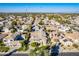 An aerial view showcasing a two-story house, neatly landscaped yard, and surrounding neighborhood at 3798 E Latham Ct, Gilbert, AZ 85297