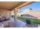 Landscaped backyard with grassy area and covered patio at 3798 E Latham Ct, Gilbert, AZ 85297