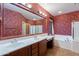 Double vanity bathroom with a large mirror and burgundy walls at 3798 E Latham Ct, Gilbert, AZ 85297