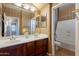 Bathroom with double sinks, a tub, and beige tile flooring at 3798 E Latham Ct, Gilbert, AZ 85297