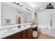 Bright bathroom boasts double sinks, a large mirror, and a separate tub and shower at 3798 E Latham Ct, Gilbert, AZ 85297