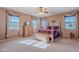 Spacious bedroom with a wooden bed frame and ample natural light at 3798 E Latham Ct, Gilbert, AZ 85297