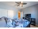 Bedroom with a ceiling fan, gray bedding, and a TV at 3798 E Latham Ct, Gilbert, AZ 85297