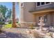 Landscaped front yard with a tiered fountain and palm trees at 3798 E Latham Ct, Gilbert, AZ 85297