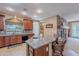 Open kitchen with a large island, stone fireplace and breakfast nook at 3798 E Latham Ct, Gilbert, AZ 85297