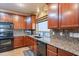 Spacious kitchen with granite countertops and dark wood cabinets at 3798 E Latham Ct, Gilbert, AZ 85297