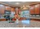 Kitchen boasts granite counters, island, and dark wood cabinets at 3798 E Latham Ct, Gilbert, AZ 85297