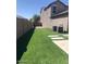 Artificial turf backyard with access gate at 42206 W Capistrano Dr, Maricopa, AZ 85138