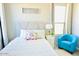 Bright bedroom with comfy bed and sitting chair at 42206 W Capistrano Dr, Maricopa, AZ 85138