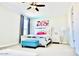 Bright bedroom with plush bed, and a teal ottoman at 42206 W Capistrano Dr, Maricopa, AZ 85138
