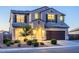 Two-story house with landscaped yard and a brown double garage door at 42206 W Capistrano Dr, Maricopa, AZ 85138