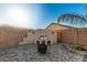 Charming firepit area with built-in seating at 42206 W Capistrano Dr, Maricopa, AZ 85138