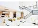 Spacious living room with high ceilings and modern sectional sofa at 42206 W Capistrano Dr, Maricopa, AZ 85138