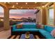 Covered patio with sectional sofa and string lights at 42206 W Capistrano Dr, Maricopa, AZ 85138
