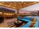 Relaxing patio with hot tub and string lights at 42206 W Capistrano Dr, Maricopa, AZ 85138