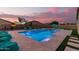 Inviting pool with lounge chairs and sunset view at 42206 W Capistrano Dr, Maricopa, AZ 85138