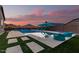 Stunning pool with lounge chairs and sunset view at 42206 W Capistrano Dr, Maricopa, AZ 85138