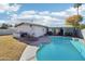 Large kidney-shaped pool in sunny backyard with patio furniture at 4601 N 75Th St, Scottsdale, AZ 85251