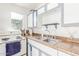 Small kitchen with white cabinets and stainless steel sink at 5309 W Gardenia Ave, Glendale, AZ 85301