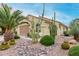 Landscaped yard with cacti and palm trees accents this home's exterior at 6569 W Yorktown Ct, Florence, AZ 85132