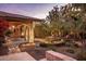 Landscaped backyard with stone pathways and seating areas at 66 Biltmore Est, Phoenix, AZ 85016