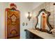 Bathroom with ornate mirror and custom painted cabinet at 66 Biltmore Est, Phoenix, AZ 85016