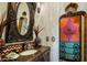 Bathroom with ornate mirror and custom painted cabinet at 66 Biltmore Est, Phoenix, AZ 85016