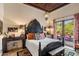 Bedroom with ornate headboard and access to a private patio at 66 Biltmore Est, Phoenix, AZ 85016