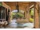 Relaxing covered patio with ornate tile floor and hanging swing chairs at 66 Biltmore Est, Phoenix, AZ 85016