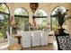 Sunlit dining room with arched windows and a large table at 66 Biltmore Est, Phoenix, AZ 85016