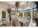 Spacious dining room with large windows and a rustic table at 66 Biltmore Est, Phoenix, AZ 85016