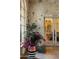 Stone entryway with large potted plant and decorative chest at 66 Biltmore Est, Phoenix, AZ 85016